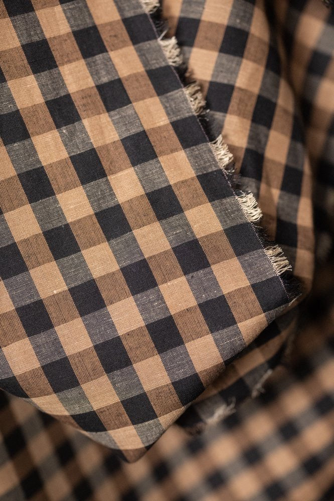 A soft cotton and linen blend in a sophisticated check of black and coffee tones - Irish Coffee.