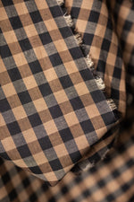 A soft cotton and linen blend in a sophisticated check of black and coffee tones - Irish Coffee.